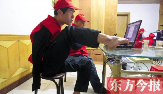 12月2日，一名“豫殘聯(lián)盟”志愿者正通過網(wǎng)絡(luò)、微博等聯(lián)絡(luò)著各地殘疾人朋友 東方今報首席記者 張曉冬