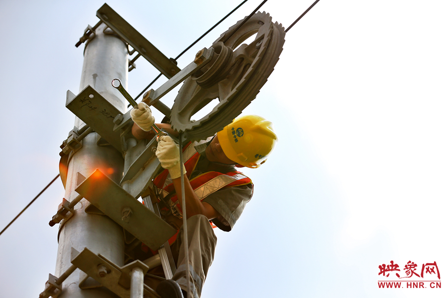 被太陽暴曬后的線桿碰著就能燙紅皮膚，可是檢修員此刻也顧不得許多