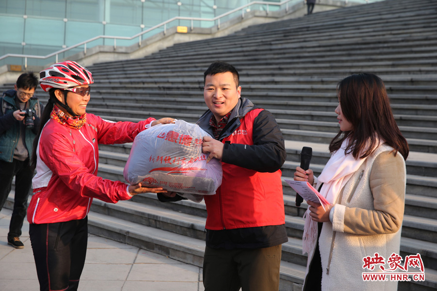 映象網(wǎng)社區(qū)負責(zé)人趙旭東（中）代表山里的孩子接受捐贈