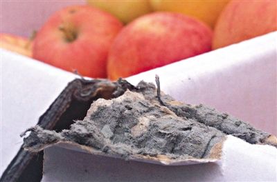 8月29日，新發(fā)地市場，一箱用“加重紙箱”包裝的蘋果正待售，紙箱夾層內(nèi)灰黑色的增重填充物清晰可見